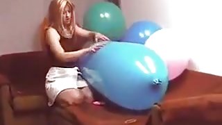 Riding a blue zeppelin shaped balloon till pop